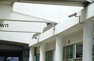 Bullet cameras mounted along a dealership forecourt canopy