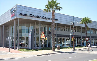 Audi Centre Cape Town dealership on a palm-lined street