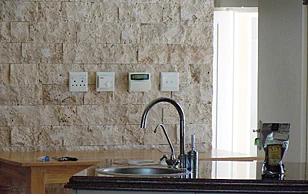 Alarm keypad and electrical points set into a stone interior wall